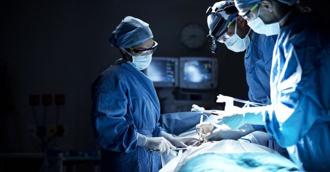 Three surgeons in an operating room. 