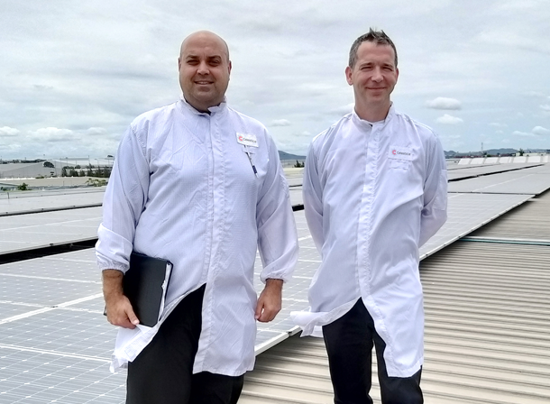 Celestica employees on a solar paneled roof top