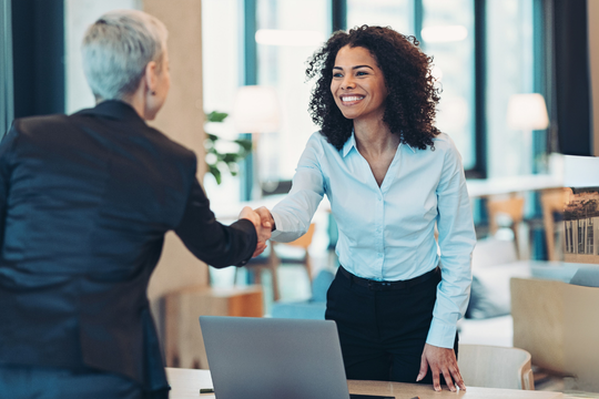 Two female business partners shaking hands
