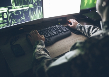 soldier looking at a computer screen