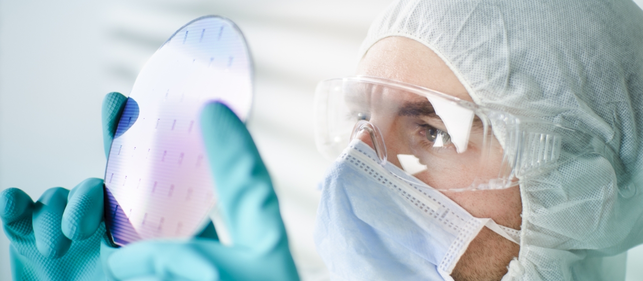 engineer inspecting a wafer